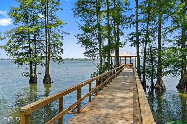 a view of balcony with wooden floor and fence