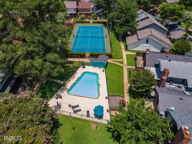 an aerial view of a house with a yard and trees