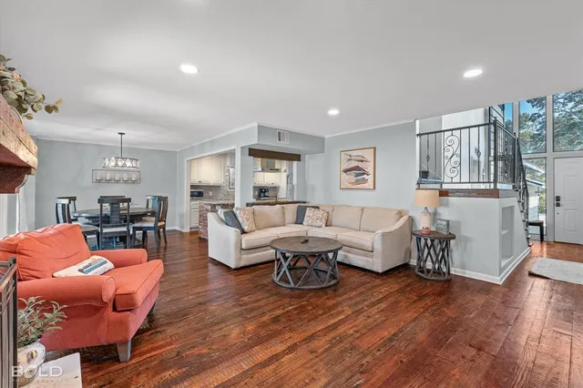a living room with furniture or wooden floor and a large window