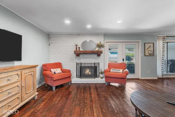 a living room with furniture a fireplace and flat screen tv
