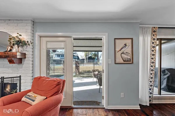 a living room with furniture a front door and a fireplace