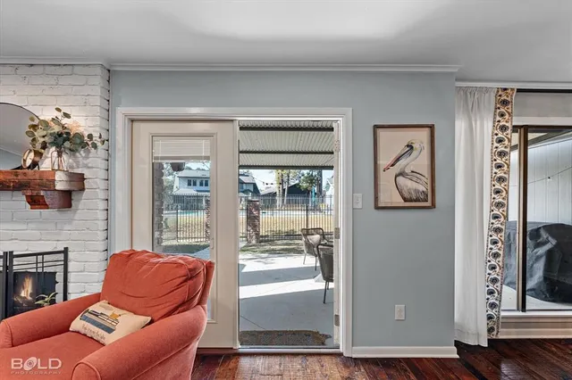 a living room with furniture a front door and a fireplace