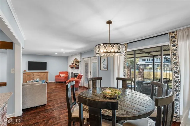 a view of a dining room with furniture wooden floor and chandelier