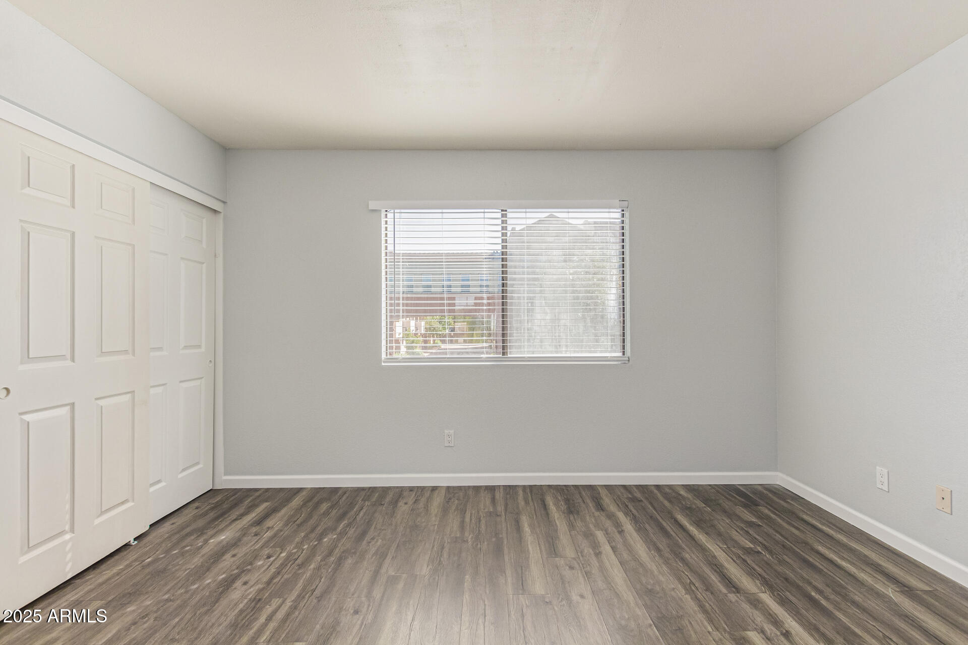 548 South Wilson Street, Unit 104 Tempe, AZ 85281 - Photo 11 of 18 an empty room with wooden floor and windows