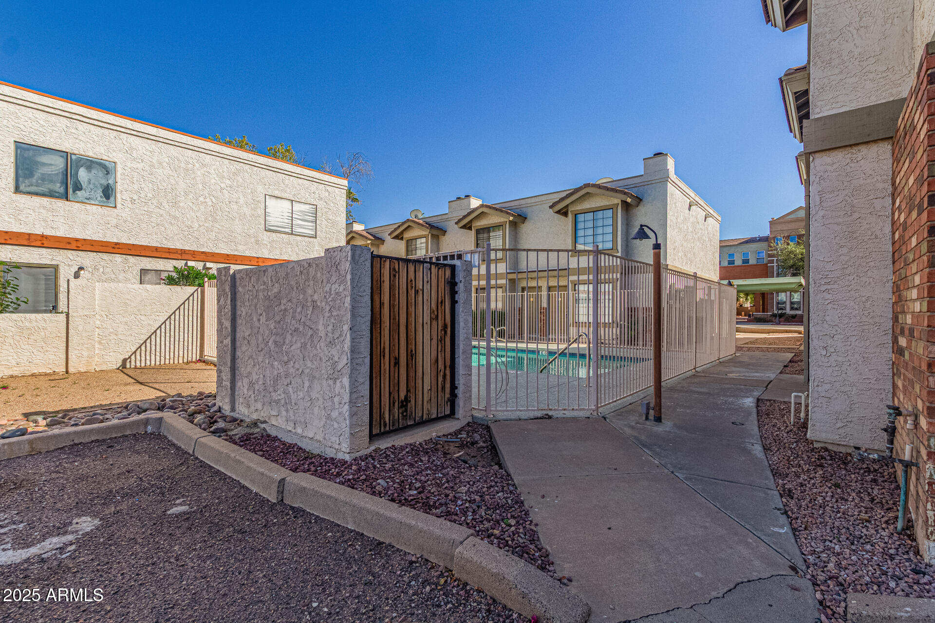 548 South Wilson Street, Unit 104 Tempe, AZ 85281 - Photo 18 of 18 a view of a blue house with a large parking space and a car parked in front of it