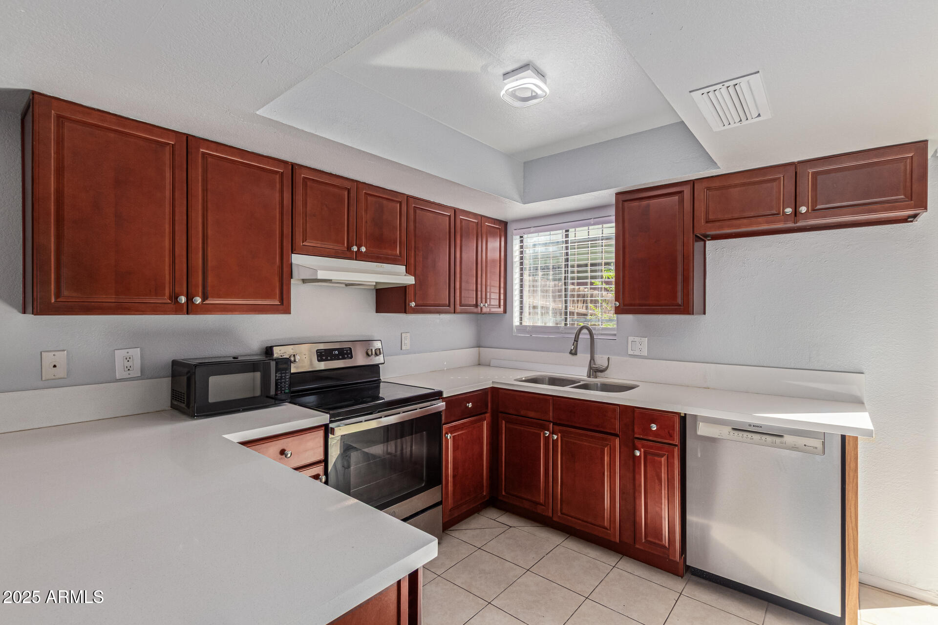 548 South Wilson Street, Unit 104 Tempe, AZ 85281 - Photo 3 of 18 a kitchen with a sink dishwasher stove and cabinets