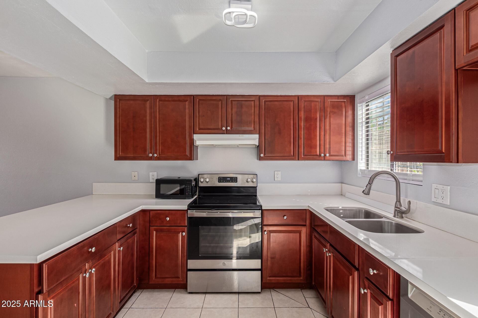 548 South Wilson Street, Unit 104 Tempe, AZ 85281 - Photo 4 of 18 a kitchen with a sink stove top oven and cabinets