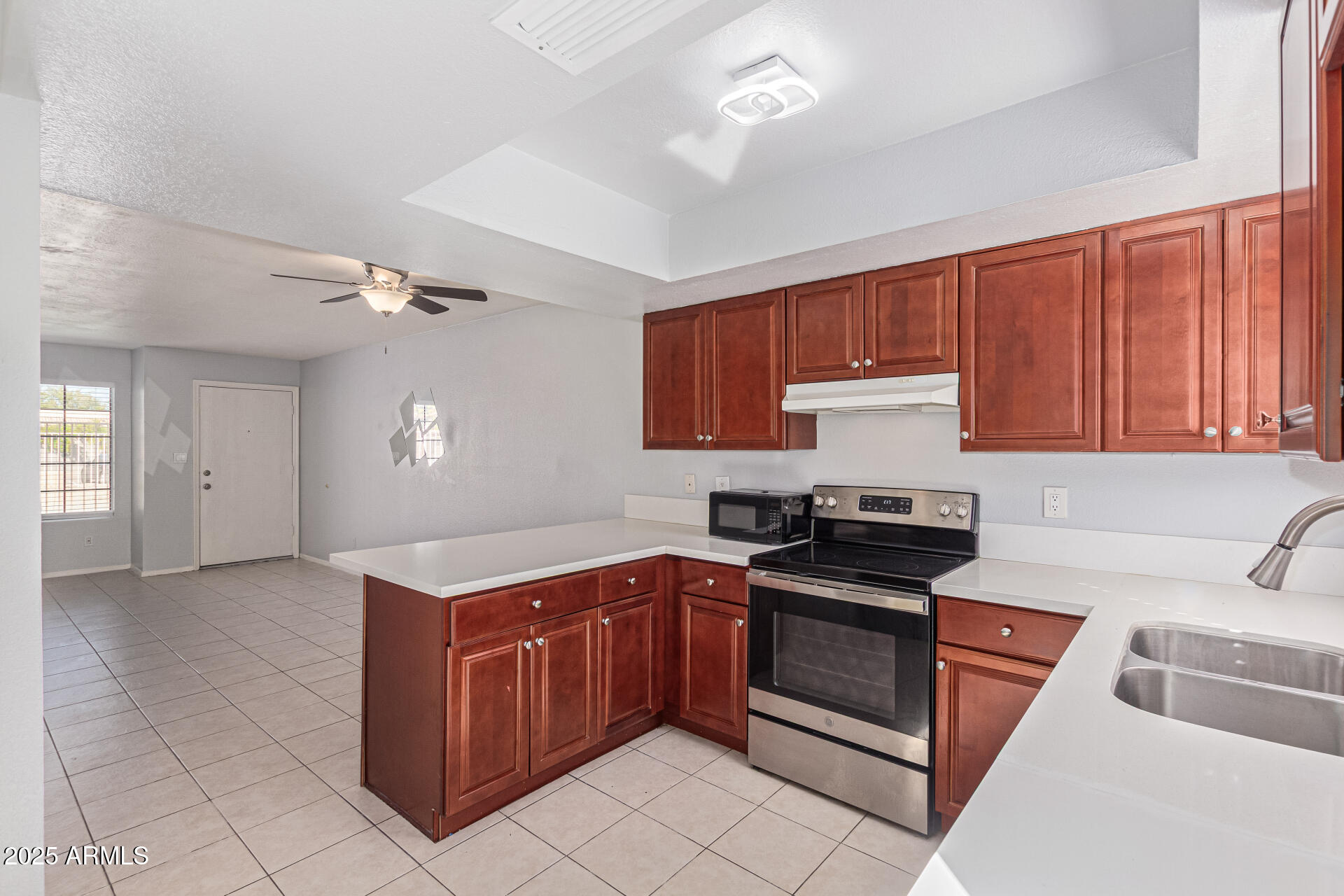 548 South Wilson Street, Unit 104 Tempe, AZ 85281 - Photo 6 of 18 a kitchen with stainless steel appliances granite countertop a sink stove and cabinets