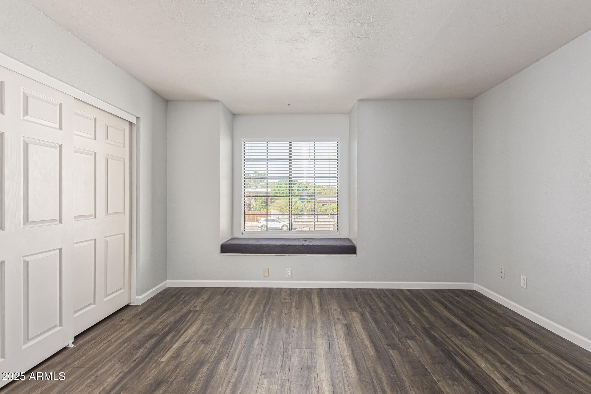 548 South Wilson Street, Unit 104 Tempe, AZ 85281 - Photo 7 of 18 a view of an empty room with wooden floor and a window
