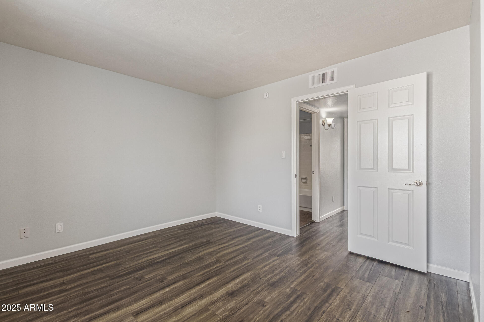 548 South Wilson Street, Unit 104 Tempe, AZ 85281 - Photo 9 of 18 a view of an empty room with wooden floor
