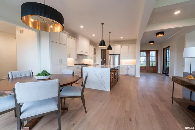 a dining room with furniture and wooden floor