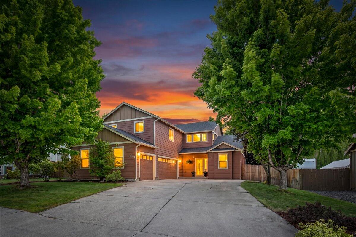 1339 Southwest Rimrock Way Redmond, OR 97756 - Photo 1 of 26 a front view of a house with a yard and garage