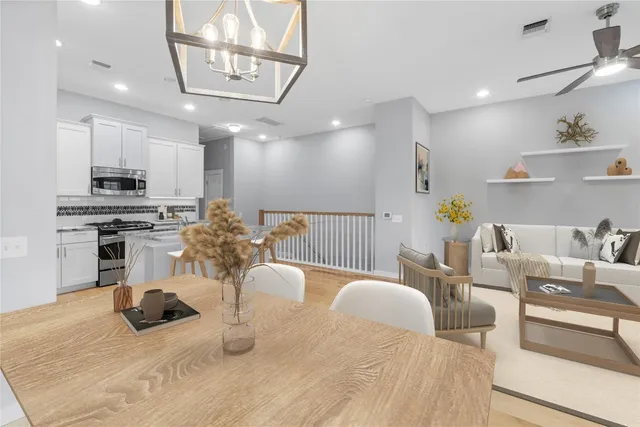 a kitchen with stainless steel appliances kitchen island granite countertop a sink and cabinets