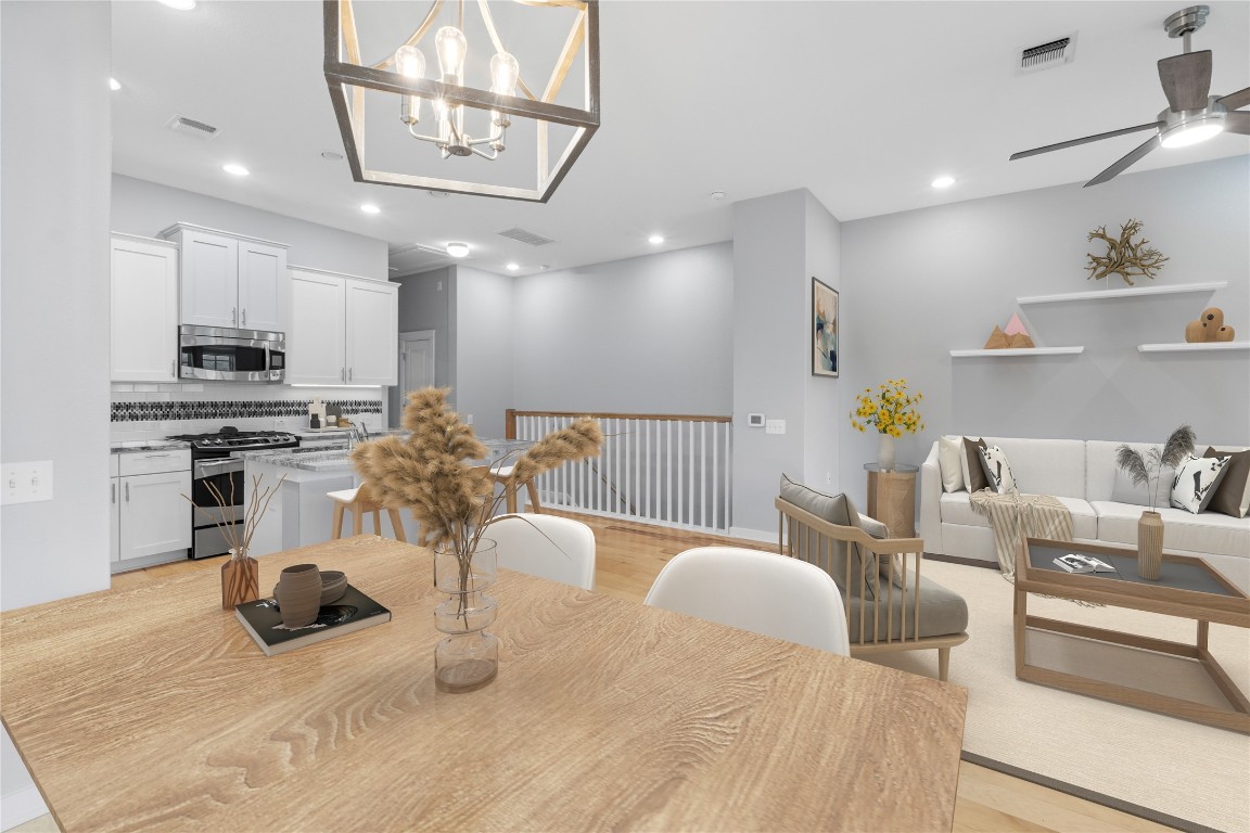 3900 Threadgill Street, Unit 16 Austin, TX 78723 - Photo 14 of 40 a kitchen with stainless steel appliances kitchen island granite countertop a sink and cabinets