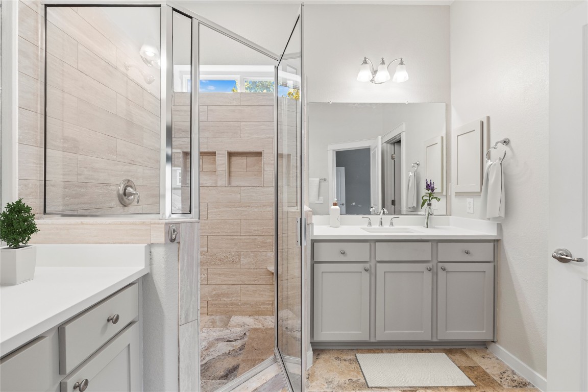 3900 Threadgill Street, Unit 16 Austin, TX 78723 - Photo 18 of 40 a bathroom with a double vanity sink mirror and shower