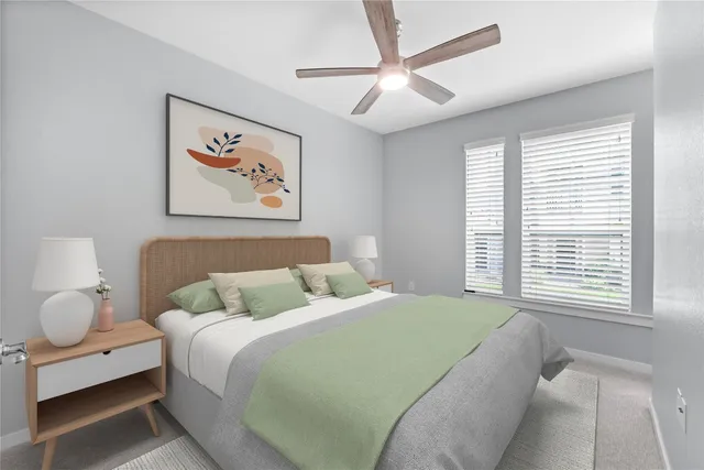 a bedroom with a bed and a large window