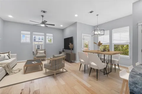 a living room with furniture a window and a flat screen tv