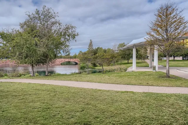 a wooden bench sitting in the middle of a park