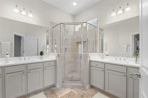a bathroom with a double vanity sink mirror and double