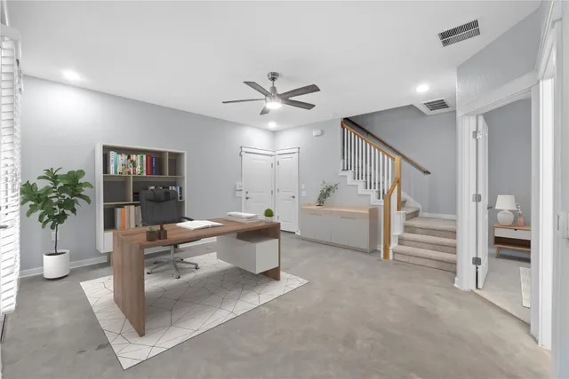 a living room with furniture a ceiling fan and a window