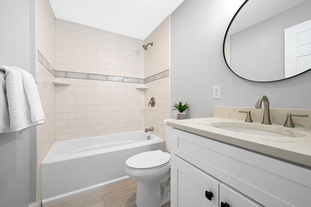 217 Marked Tree Road Holliston, MA 01746 - Photo 14 of 30 a bathroom with a sink a toilet and a mirror