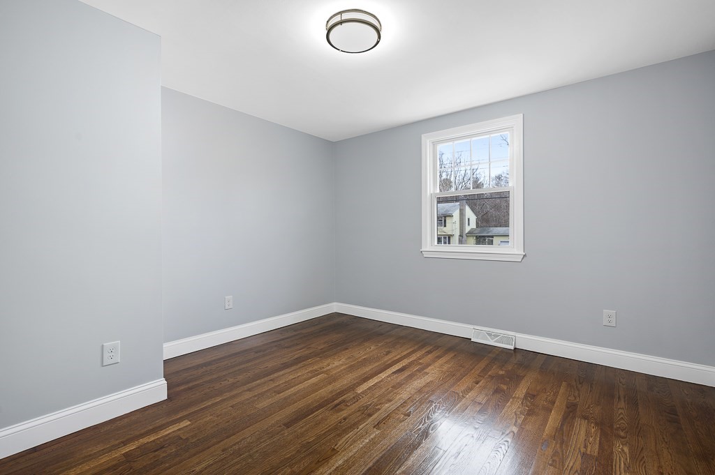 217 Marked Tree Road Holliston, MA 01746 - Photo 16 of 30 an empty room with wooden floor and windows