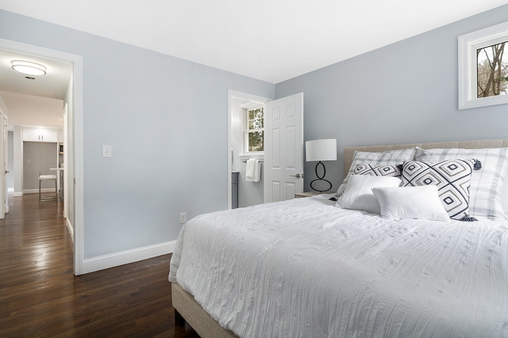 217 Marked Tree Road Holliston, MA 01746 - Photo 17 of 30 a bedroom with a large bed and wooden floor