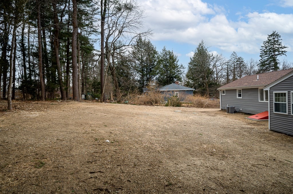 217 Marked Tree Road Holliston, MA 01746 - Photo 29 of 30 a view of patio with a table and chairs under an umbrella