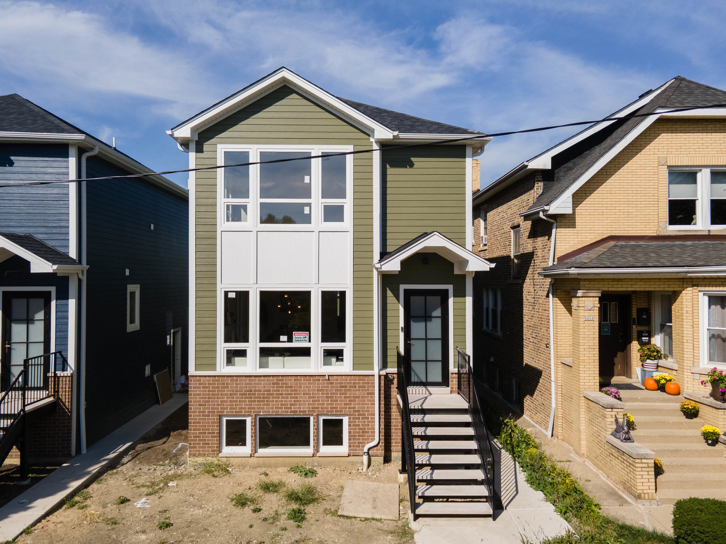 5254 West Newport Avenue Chicago, IL 60641 - Photo 3 of 27 a front view of a house with a yard