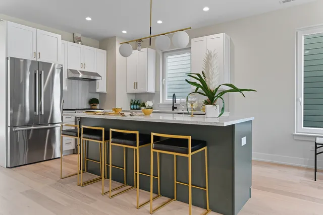 a kitchen with kitchen island stainless steel appliances a sink and counter space