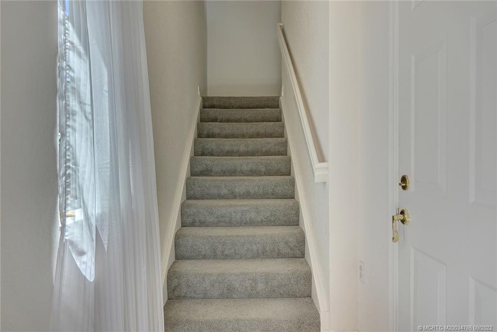 63 Southeast Palermo, Unit 202 Stuart, FL 34994 - Photo 11 of 30 a view of staircase with white walls