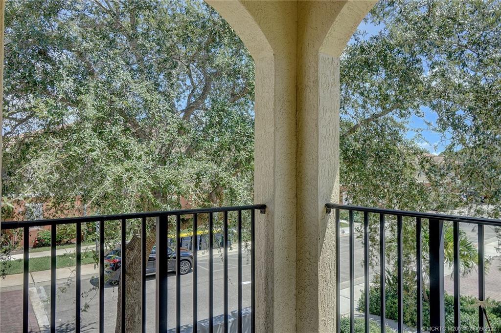 63 Southeast Palermo, Unit 202 Stuart, FL 34994 - Photo 2 of 30 a balcony with wooden fence