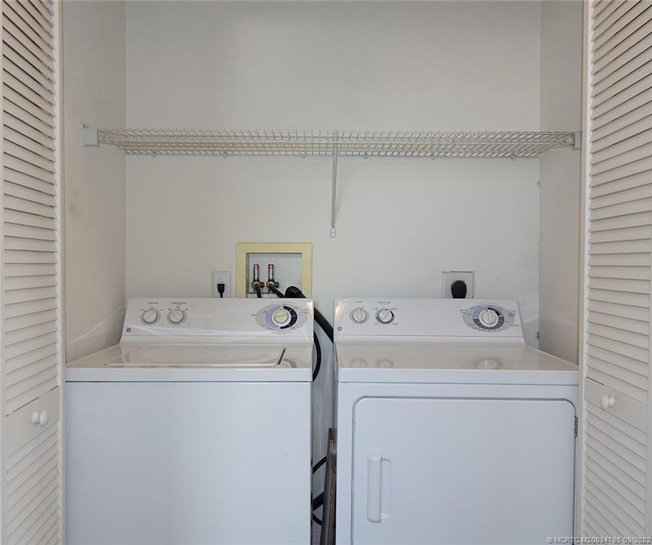 63 Southeast Palermo, Unit 202 Stuart, FL 34994 - Photo 29 of 30 a utility room with dryer and washer