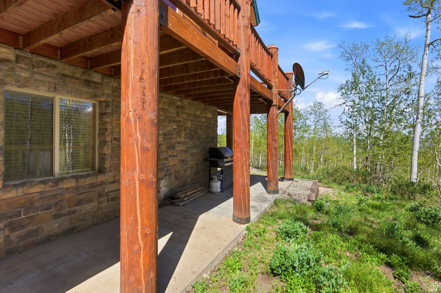 2096 South Aspen Ridge Coalville, UT 84017 - Photo 39 of 44 Covered patio with stone veneer siding and exposed wood beam supports
