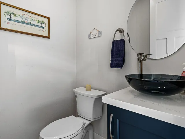 a bathroom with a granite countertop sink a large mirror and a shower