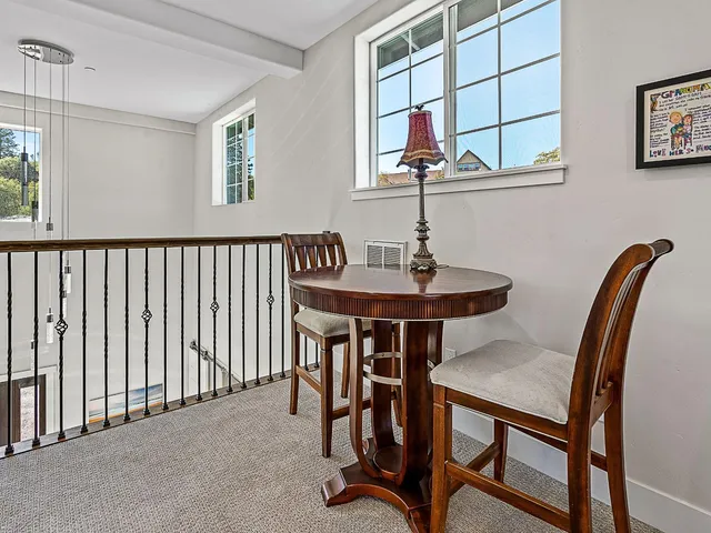 a view of balcony with wooden floor and seating space