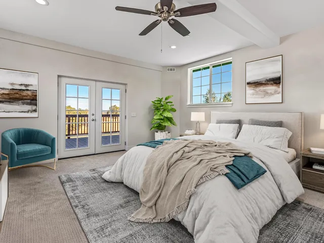 a view of a patio with table and chairs under an umbrella with a barbeque