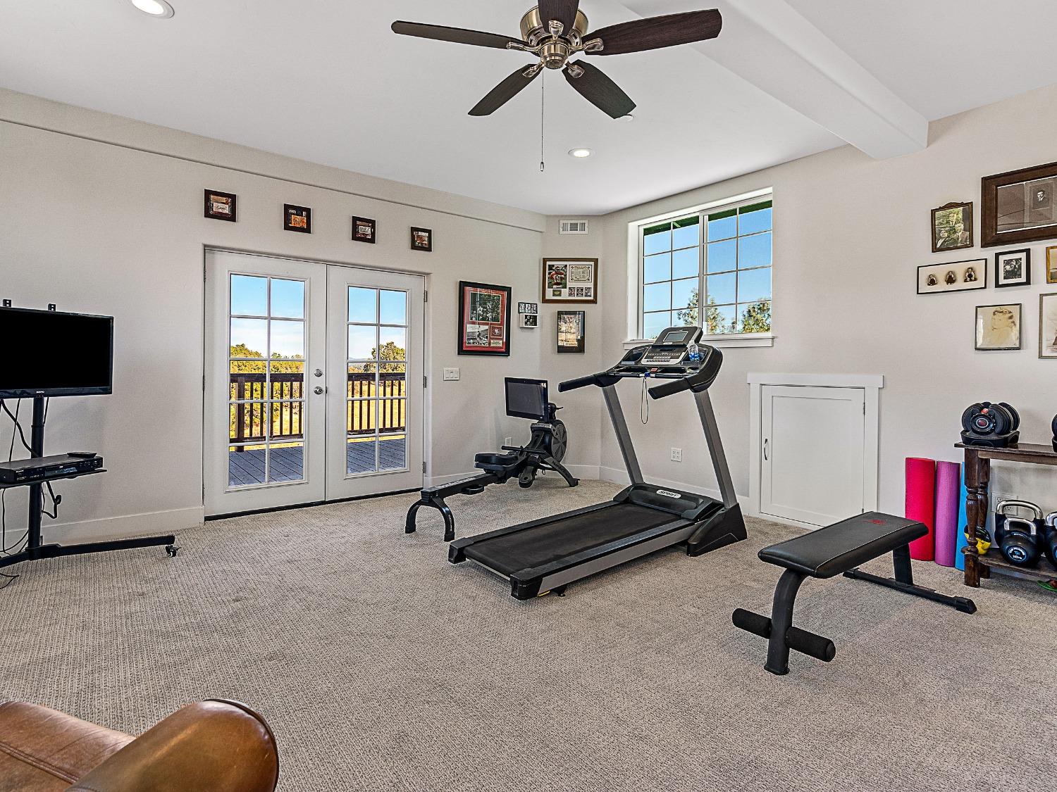 3102 Squirrel Hollow Mount Aukum, CA 95656 - Photo 27 of 51 a view of a livingroom with furniture and a gym cycle