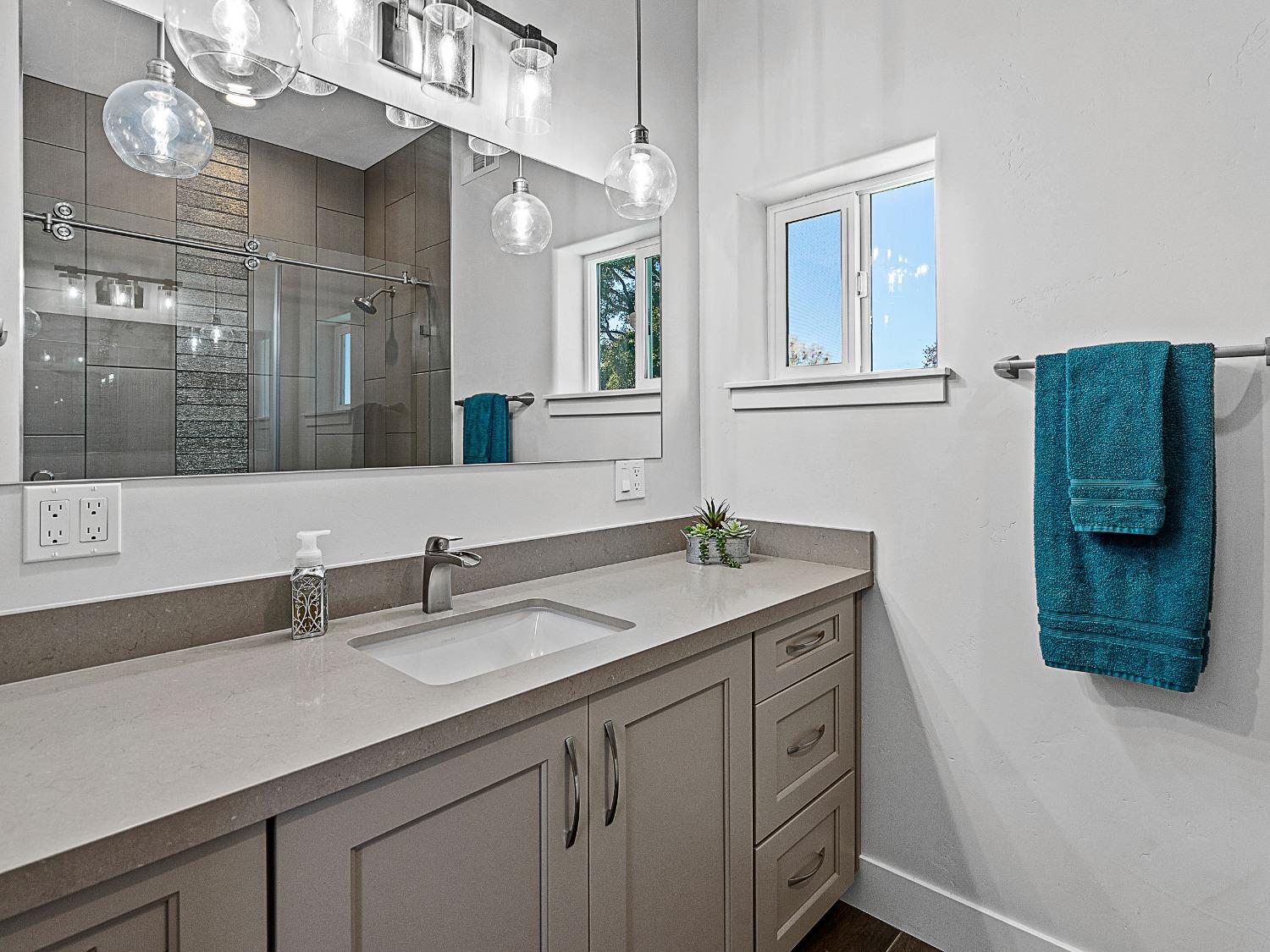 3102 Squirrel Hollow Mount Aukum, CA 95656 - Photo 28 of 51 a bathroom with a granite countertop sink a large mirror and a shower