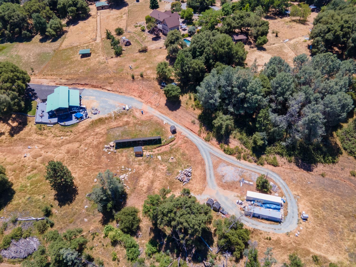 3102 Squirrel Hollow Mount Aukum, CA 95656 - Photo 47 of 51 an aerial view of a house with a yard and large trees
