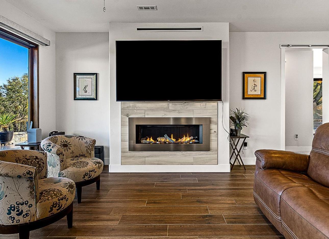 3102 Squirrel Hollow Mount Aukum, CA 95656 - Photo 5 of 51 a living room with furniture a flat screen tv and a fireplace