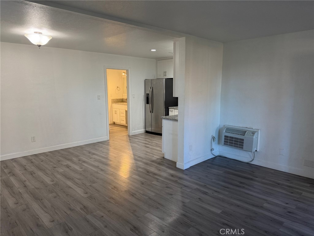 1010 West MacArthur Boulevard, Unit 147 Santa Ana, CA 92707 - Photo 2 of 12 a view of empty room with wooden floor