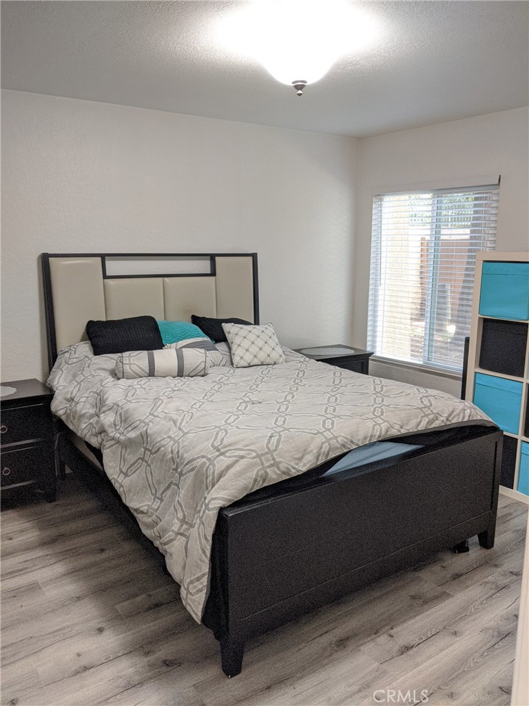 1010 West MacArthur Boulevard, Unit 147 Santa Ana, CA 92707 - Photo 8 of 12 a bedroom with a bed and window