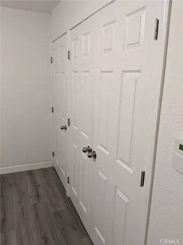 a view of a room with wooden floor