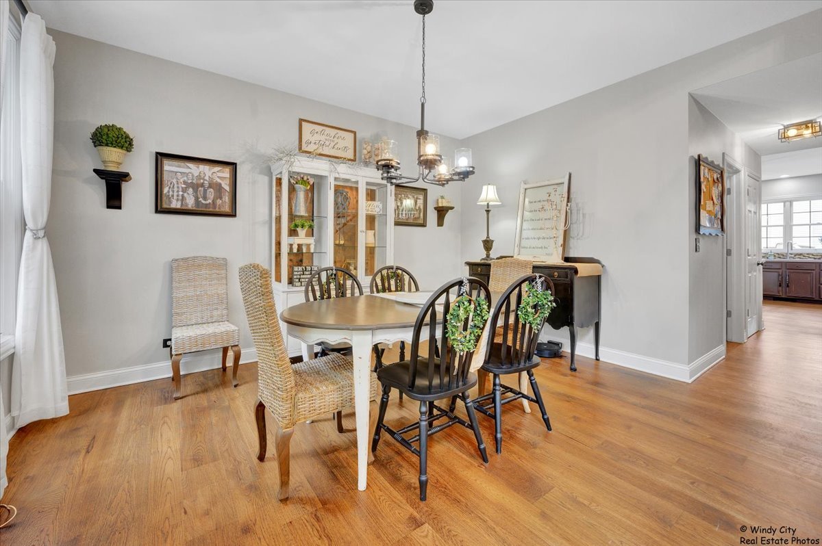 1880 Crofton Drive Algonquin, IL 60102 - Photo 17 of 44 a view of a dining room with furniture wooden floor and chandelier