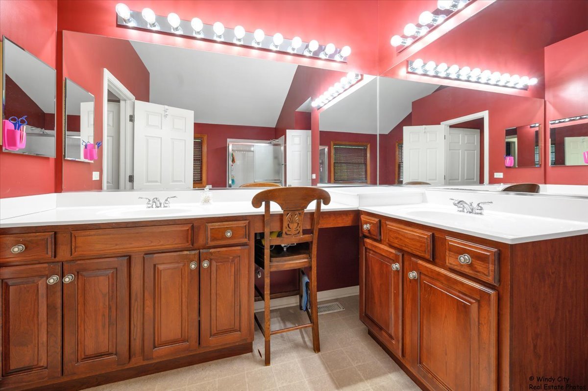 1880 Crofton Drive Algonquin, IL 60102 - Photo 22 of 44 a bathroom with a sink vanity and a mirror