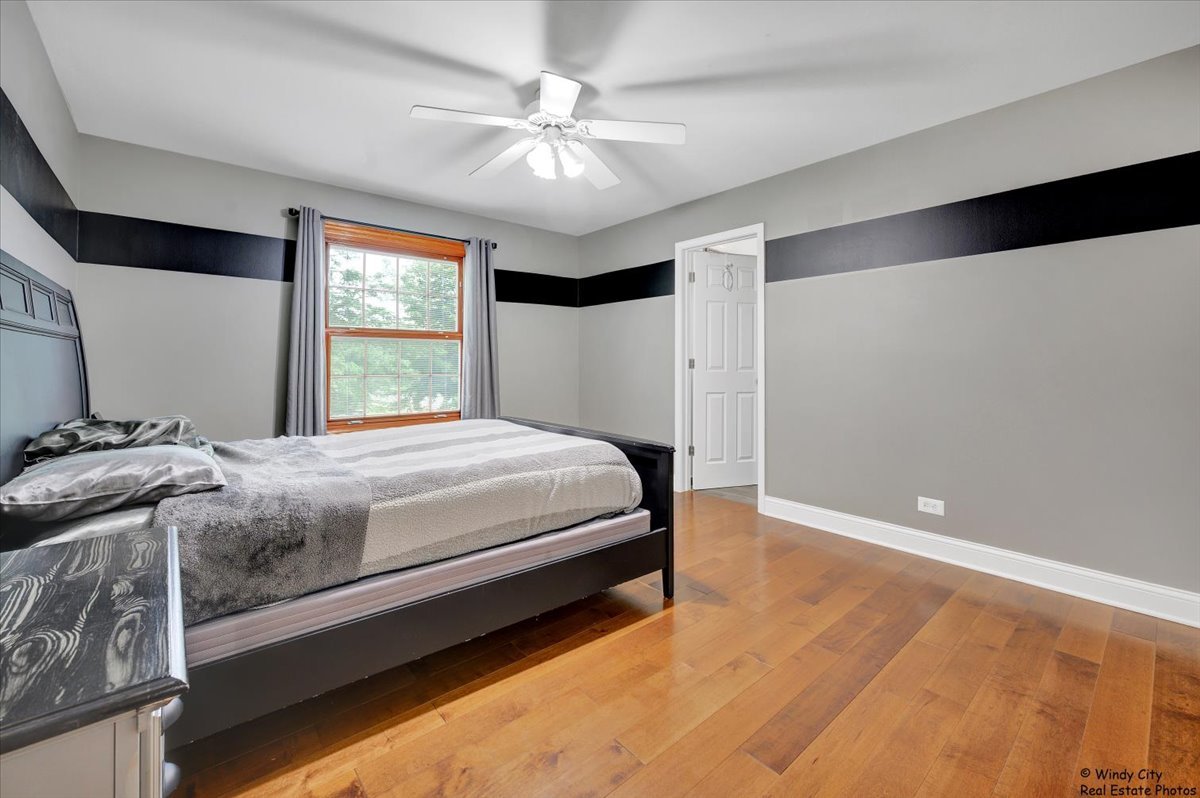 1880 Crofton Drive Algonquin, IL 60102 - Photo 25 of 44 a bedroom with a bed and a ceiling fan