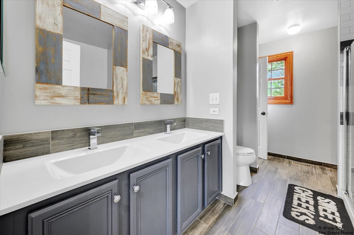 1880 Crofton Drive Algonquin, IL 60102 - Photo 27 of 44 a bathroom with a sink and a mirror