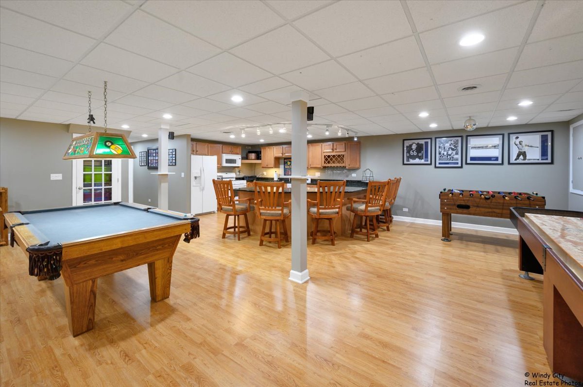 1880 Crofton Drive Algonquin, IL 60102 - Photo 35 of 44 a room with lots of furniture and a flat screen tv