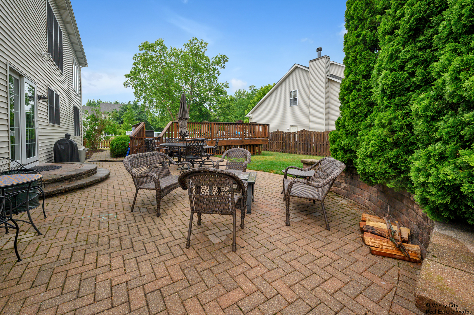 1880 Crofton Drive Algonquin, IL 60102 - Photo 40 of 44 a view of a patio with a dining table and chairs with wooden fence and plants